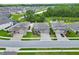 Aerial view of homes situated in a residential area, surrounded by greenery and a pond at 17845 Cortes Creek Blvd, Spring Hill, FL 34610