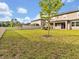 Expansive backyard features lush green grass, a white fence, and ample space for recreation at 17845 Cortes Creek Blvd, Spring Hill, FL 34610