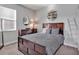 Cozy bedroom features a dark wood frame, dresser, neutral paint and carpet, and tasteful decorative ladder and shelving at 17845 Cortes Creek Blvd, Spring Hill, FL 34610