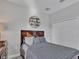 Stylish bedroom features a wood bedframe and decorative shelving with a view of a double closet and neutral paint at 17845 Cortes Creek Blvd, Spring Hill, FL 34610