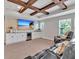 Bonus room featuring recessed lighting, a tray ceiling with wood beams, and a wet bar with comfortable reclining furniture at 17845 Cortes Creek Blvd, Spring Hill, FL 34610