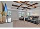 Upstairs bonus room with decorative wood beams, comfortable seating, and an entertainment center at 17845 Cortes Creek Blvd, Spring Hill, FL 34610