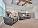 Upstairs bonus room with comfortable seating, tray ceilings with wood beams, and attractive natural light at 17845 Cortes Creek Blvd, Spring Hill, FL 34610
