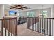 Bonus room features a tray ceiling with wooden beams, recessed lighting, reclining seating and light-filled windows at 17845 Cortes Creek Blvd, Spring Hill, FL 34610