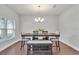 Elegant dining room features chandelier, dark wood floors and a large window at 17845 Cortes Creek Blvd, Spring Hill, FL 34610