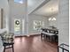 View of foyer and dining room with chandelier, dark wood floors and plenty of natural light at 17845 Cortes Creek Blvd, Spring Hill, FL 34610