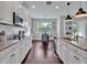 Open kitchen with stainless steel appliances, granite countertops and eat-in dining area at 17845 Cortes Creek Blvd, Spring Hill, FL 34610