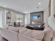 Inviting living room features a sleek, modern fireplace and built-in shelving for added style at 17845 Cortes Creek Blvd, Spring Hill, FL 34610