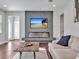 Contemporary living room with a modern fireplace, TV, and comfortable seating arrangement at 17845 Cortes Creek Blvd, Spring Hill, FL 34610