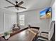 Bright home office featuring a ceiling fan, comfortable chairs, and desk at 17845 Cortes Creek Blvd, Spring Hill, FL 34610
