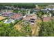 Aerial view of neighborhood featuring mature trees, swimming pools and well-manicured landscaping at 17914 Bramshot Pl, Lutz, FL 33559