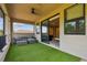 Balcony with artificial turf, patio seating, and access to the home theater room at 17914 Bramshot Pl, Lutz, FL 33559
