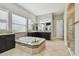 This bathroom has a walk in shower, large soaking tub, and dark wooden cabinets at 17914 Bramshot Pl, Lutz, FL 33559