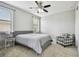 Bedroom with ceiling fan, chair, and natural light at 17914 Bramshot Pl, Lutz, FL 33559