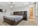 Spacious bedroom featuring dark wood furniture, recessed lighting and a view into the bathroom at 17914 Bramshot Pl, Lutz, FL 33559