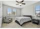 Bedroom featuring a chair, ceiling fan and two windows at 17914 Bramshot Pl, Lutz, FL 33559