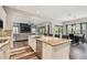 The kitchen features an island with granite counters, stainless steel appliances and an open concept design at 17914 Bramshot Pl, Lutz, FL 33559
