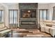 Open concept living room with modern fireplace and large TV at 17914 Bramshot Pl, Lutz, FL 33559