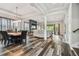 Open-concept living and dining area showcasing wood-look floors and abundant natural light at 17914 Bramshot Pl, Lutz, FL 33559