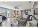 Entertaining room with luxury vinyl flooring, large sofa, and walls decorated with sports memorabilia at 17914 Bramshot Pl, Lutz, FL 33559