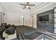 This main bedroom features a ceiling fan and a stone wall with a tv mounted to it at 17914 Bramshot Pl, Lutz, FL 33559