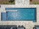 Aerial close-up of a pristine rectangular pool with shimmering turquoise water at 17914 Bramshot Pl, Lutz, FL 33559