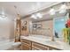 Well-lit bathroom with vanity, wallpaper, shower/tub, and a neutral color scheme at 17980 Gulf Blvd # 505, Redington Shores, FL 33708
