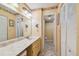 Traditional bathroom with vanity, decorative mirror, and adjacent toilet room at 17980 Gulf Blvd # 505, Redington Shores, FL 33708