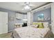 Cozy bedroom featuring a murphy bed, desk, flamingo themed decor and a ceiling fan at 17980 Gulf Blvd # 505, Redington Shores, FL 33708