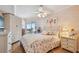 Comfortable bedroom featuring a ceiling fan, balcony access, and beach view at 17980 Gulf Blvd # 505, Redington Shores, FL 33708
