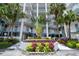 The building entrance is surrounded by tropical plants and flowers at 17980 Gulf Blvd # 505, Redington Shores, FL 33708