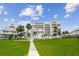 Condo building with bright green lawn, balconies, and easy access to nearby amenities at 17980 Gulf Blvd # 505, Redington Shores, FL 33708