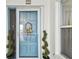 Charming front door with a wreath and decorative plants adds curb appeal to this inviting home at 17980 Gulf Blvd # 505, Redington Shores, FL 33708