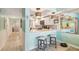 Bright kitchen area with bar seating, white cabinets, and modern lighting fixtures at 17980 Gulf Blvd # 505, Redington Shores, FL 33708