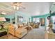 Bright living room with comfortable seating, mirror accents and sliding glass doors to the balcony at 17980 Gulf Blvd # 505, Redington Shores, FL 33708