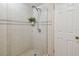 Updated walk-in shower features tiled walls, a glass panel, and corner shelf at 17980 Gulf Blvd # 505, Redington Shores, FL 33708