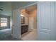 View from main bedroom into ensuite bathroom featuring a double door entrance and vanity at 19247 Otters Wick Way, Land O Lakes, FL 34638
