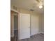 Bedroom featuring plush carpet, ceiling fan, and closet doors offering storage at 19247 Otters Wick Way, Land O Lakes, FL 34638