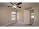 Light-filled bedroom features a ceiling fan, closet, and sunny window at 19247 Otters Wick Way, Land O Lakes, FL 34638