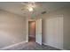 Bright bedroom with carpet, ceiling fan, walk-in closet, and white trim at 19247 Otters Wick Way, Land O Lakes, FL 34638