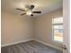 Comfortable bedroom with carpet, ceiling fan, and natural light from a window at 19247 Otters Wick Way, Land O Lakes, FL 34638