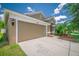 Lovely home featuring an attached two-car garage, manicured landscaping and a spacious driveway at 19247 Otters Wick Way, Land O Lakes, FL 34638