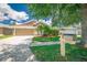 Charming single-Gathering home featuring a well-manicured lawn and a two-car garage at 19247 Otters Wick Way, Land O Lakes, FL 34638