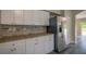 Open kitchen featuring stainless steel appliances, granite countertops, and light-colored cabinets at 19247 Otters Wick Way, Land O Lakes, FL 34638