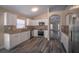 Modern kitchen featuring white cabinets, stainless steel appliances, and granite countertops at 19247 Otters Wick Way, Land O Lakes, FL 34638