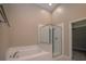 Main bathroom featuring a stand-up glass door shower, bathtub and closet at 19247 Otters Wick Way, Land O Lakes, FL 34638