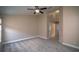 Large main bedroom featuring plush carpets, natural light, ensuite bathroom, and high vaulted ceiling at 19247 Otters Wick Way, Land O Lakes, FL 34638