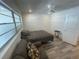 Bright bedroom features a ceiling fan, a large window and laminate flooring, offering a comfortable and modern living space at 2011 58Th N Ave # 20, St Petersburg, FL 33714