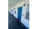 Well-lit hallway featuring vibrant blue doors, tiled floors, and large windows, offering a welcoming and bright entrance at 2011 58Th N Ave # 20, St Petersburg, FL 33714