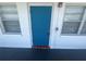 Close up on apartment door and window highlighting the bright blue door, tile accent, and natural light at 2011 58Th N Ave # 20, St Petersburg, FL 33714